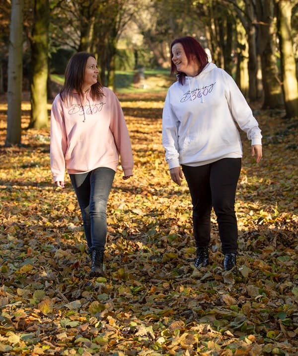Lisa and Jo walking through a forest